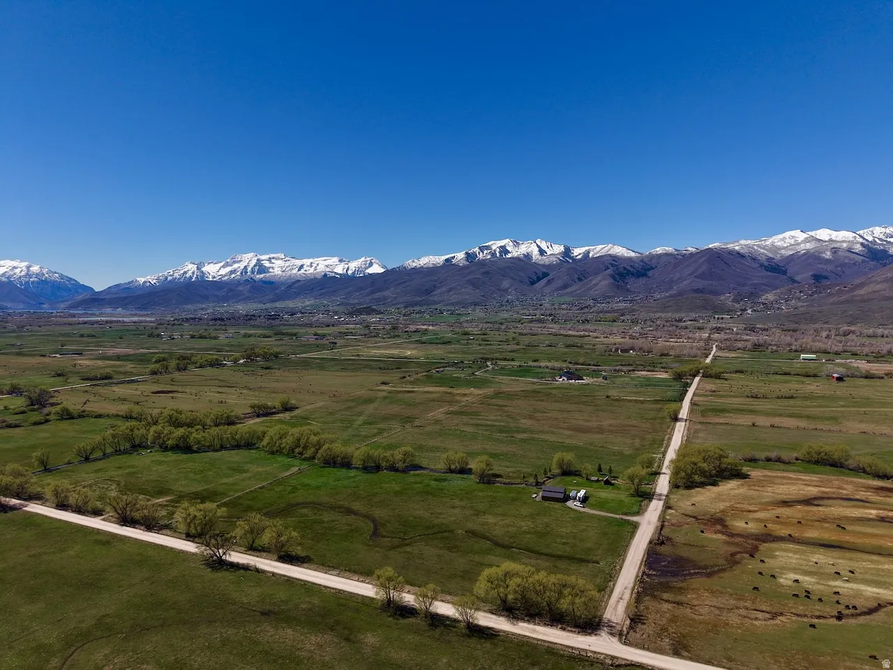 View of rural area featuring a mountain backdrop and agricultural land