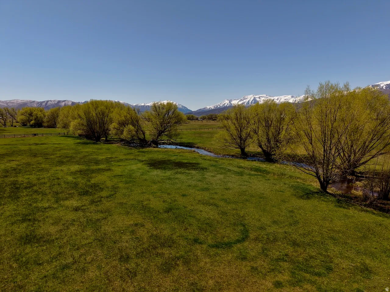 View of grassy yard featuring a view of countryside and a mountain view