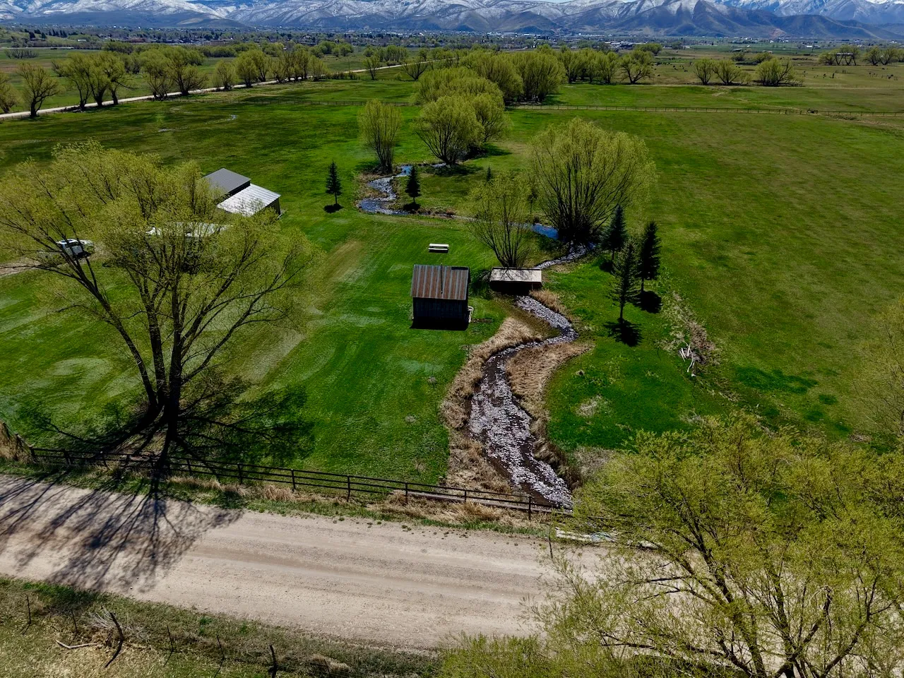 Aerial view of sparsely populated area featuring agricultural land and a mountainous background