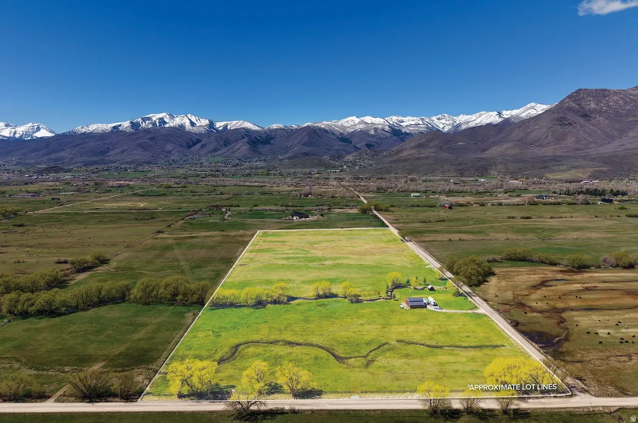 Overview of rural landscape featuring a mountainous background and a pastoral area