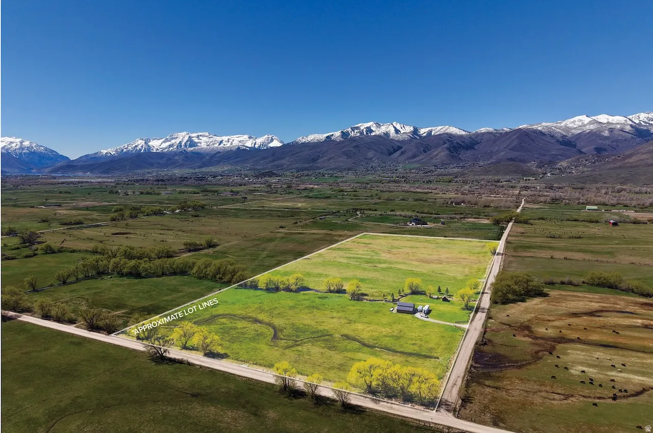 Overview of rural landscape featuring property parcel outlined and mountains