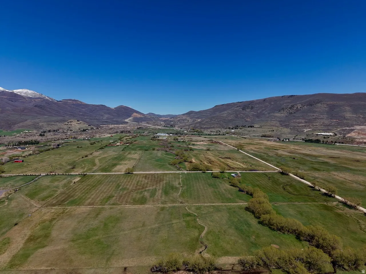 Overview of rural landscape with a mountainous background and farmland
