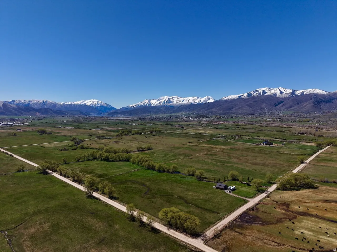 Overview of rural landscape with a mountainous background and a pastoral area