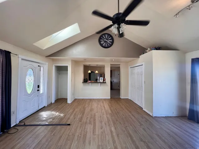 Vaulted ceiling with skylight and ceiling fan