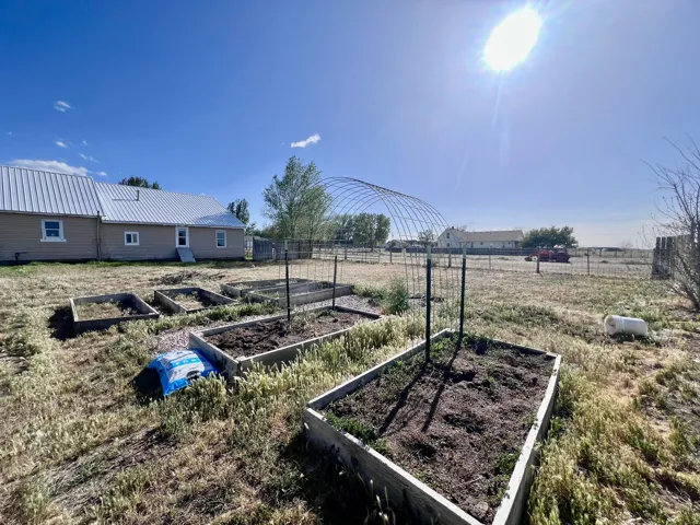 View of yard with a vegetable garden and a view of rural / pastoral area
