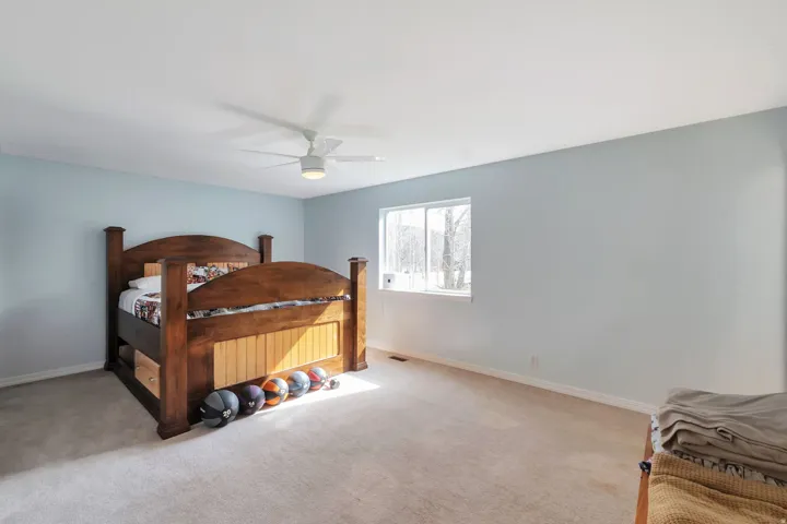 Bedroom featuring light carpet and ceiling fan