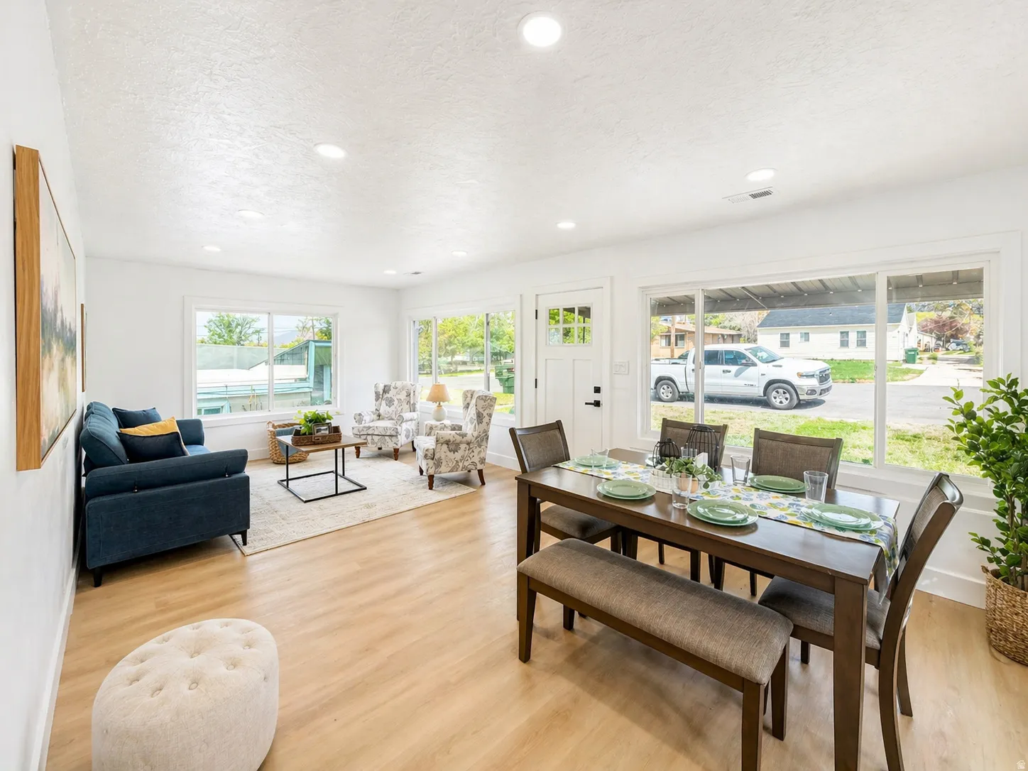 Dining room with light wood-style floors, a textured ceiling, and recessed lighting
