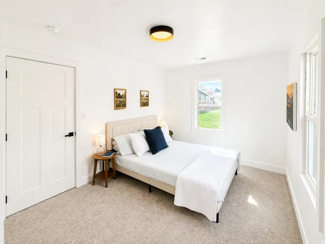 Bedroom with light carpet and baseboards