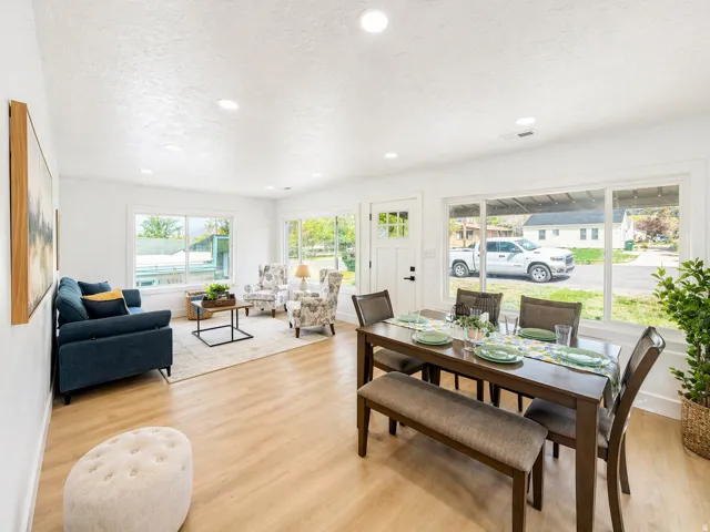 Dining room with light wood-style floors, a textured ceiling, and recessed lighting