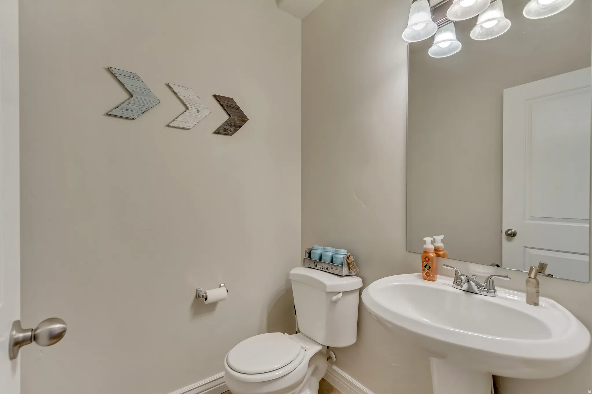 Half bathroom featuring toilet and baseboards