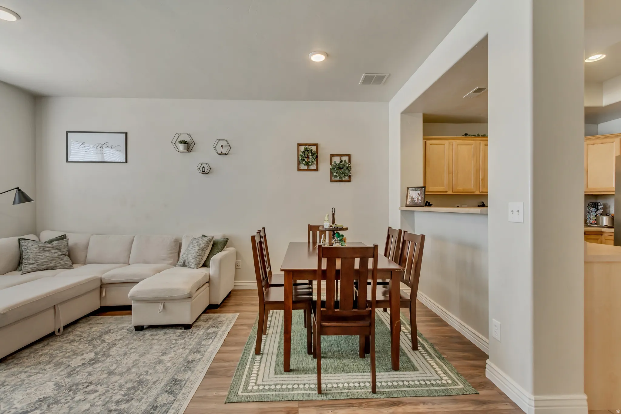 Dining area with light wood-type flooring and recessed lighting
