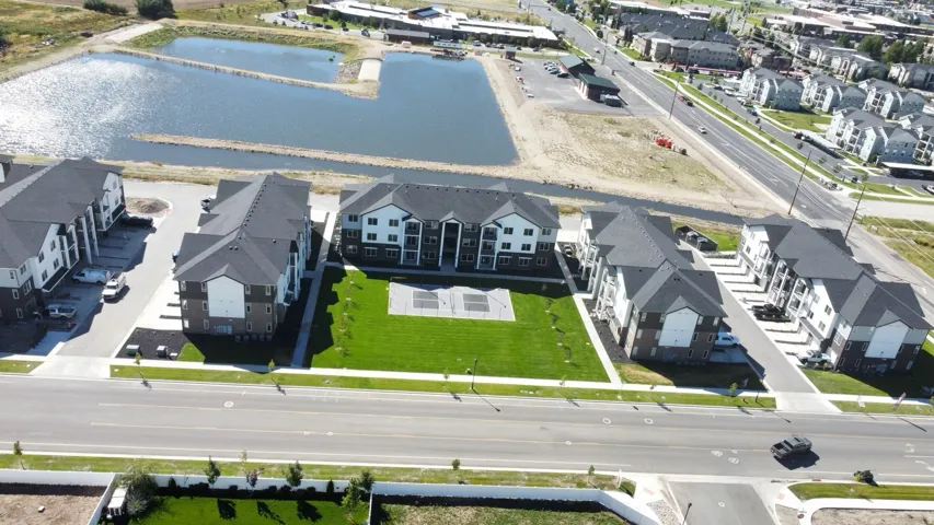 Aerial perspective of suburban area featuring a nearby body of water
