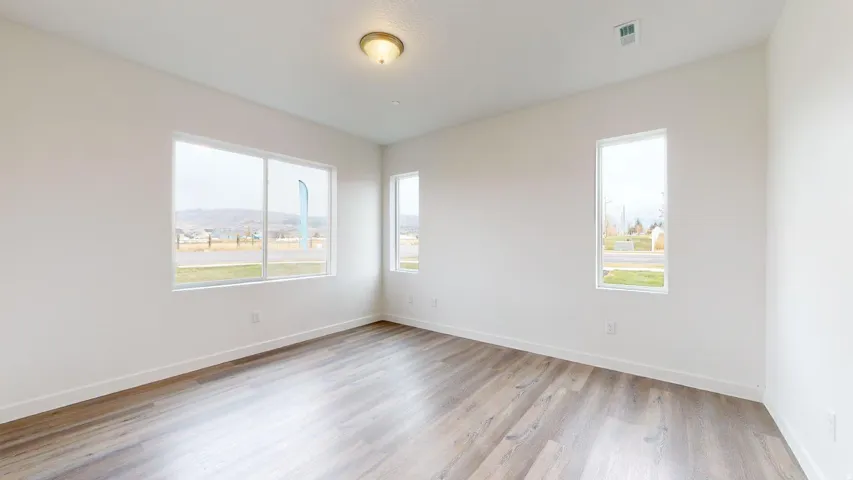 Unfurnished room featuring light wood-style floors and baseboards