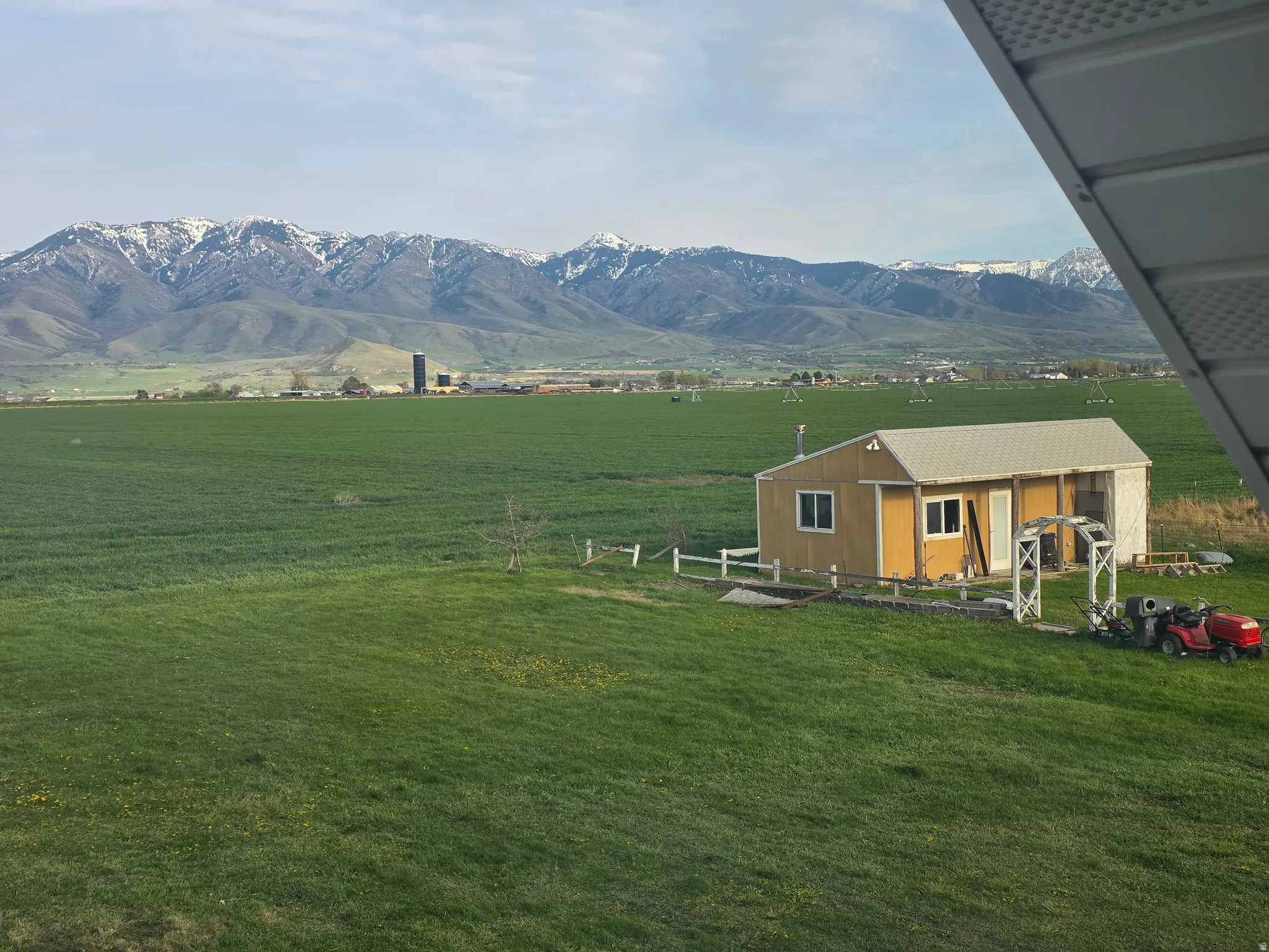 View of mountain backdrop featuring rural landscape and agricultural land