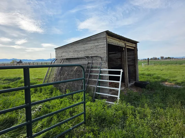 View of outbuilding featuring a view of rural / pastoral area, an exterior structure, and a mountain view