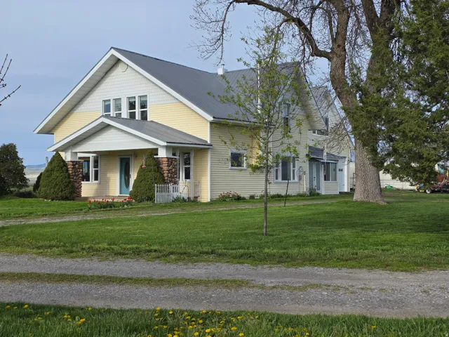 View of front of home featuring a front lawn and a metal roof