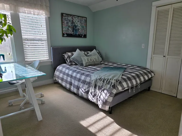 Bedroom featuring carpet floors, a closet, and vaulted ceiling