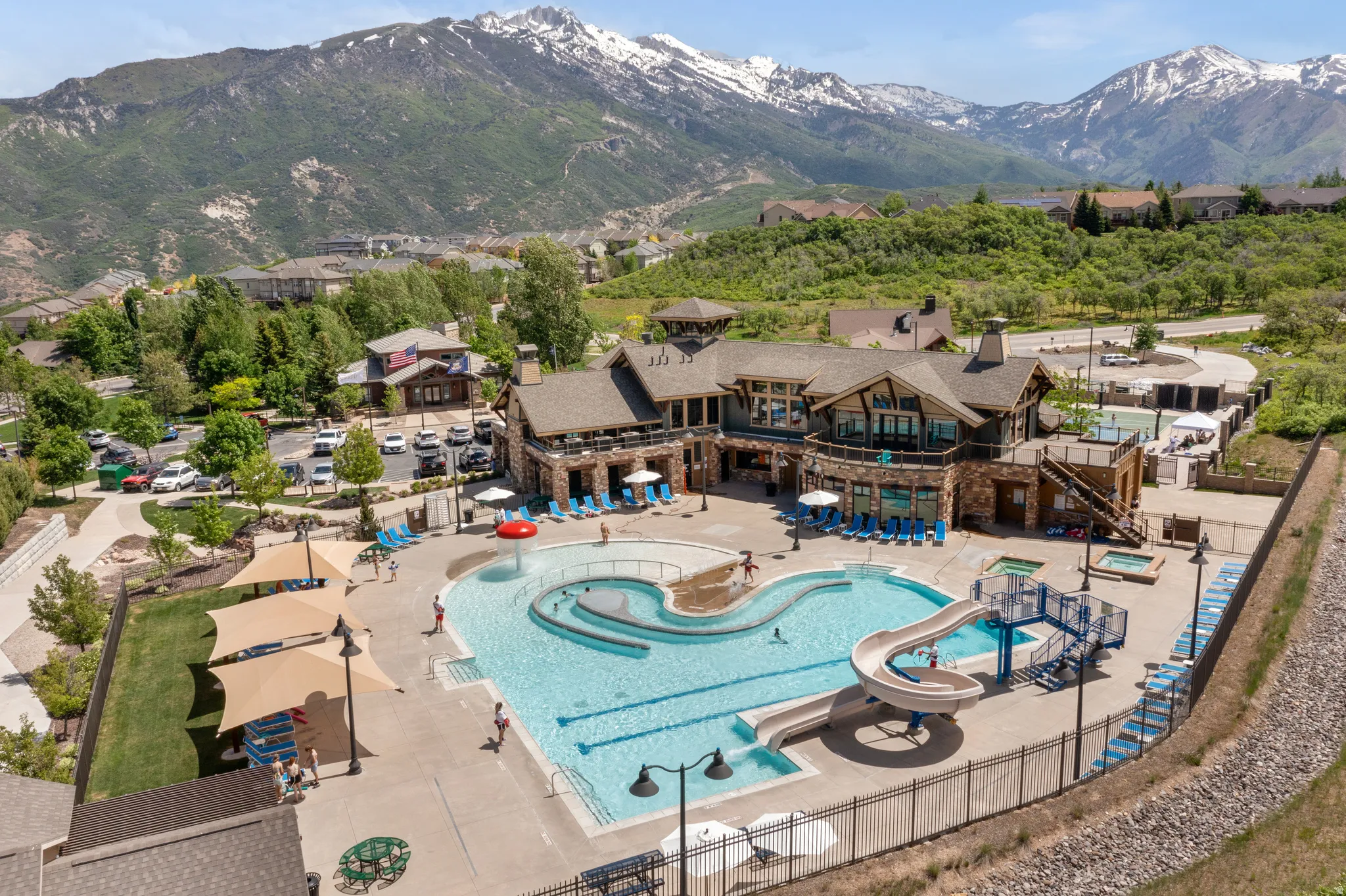 Drone / aerial view of a mountain backdrop and a pool