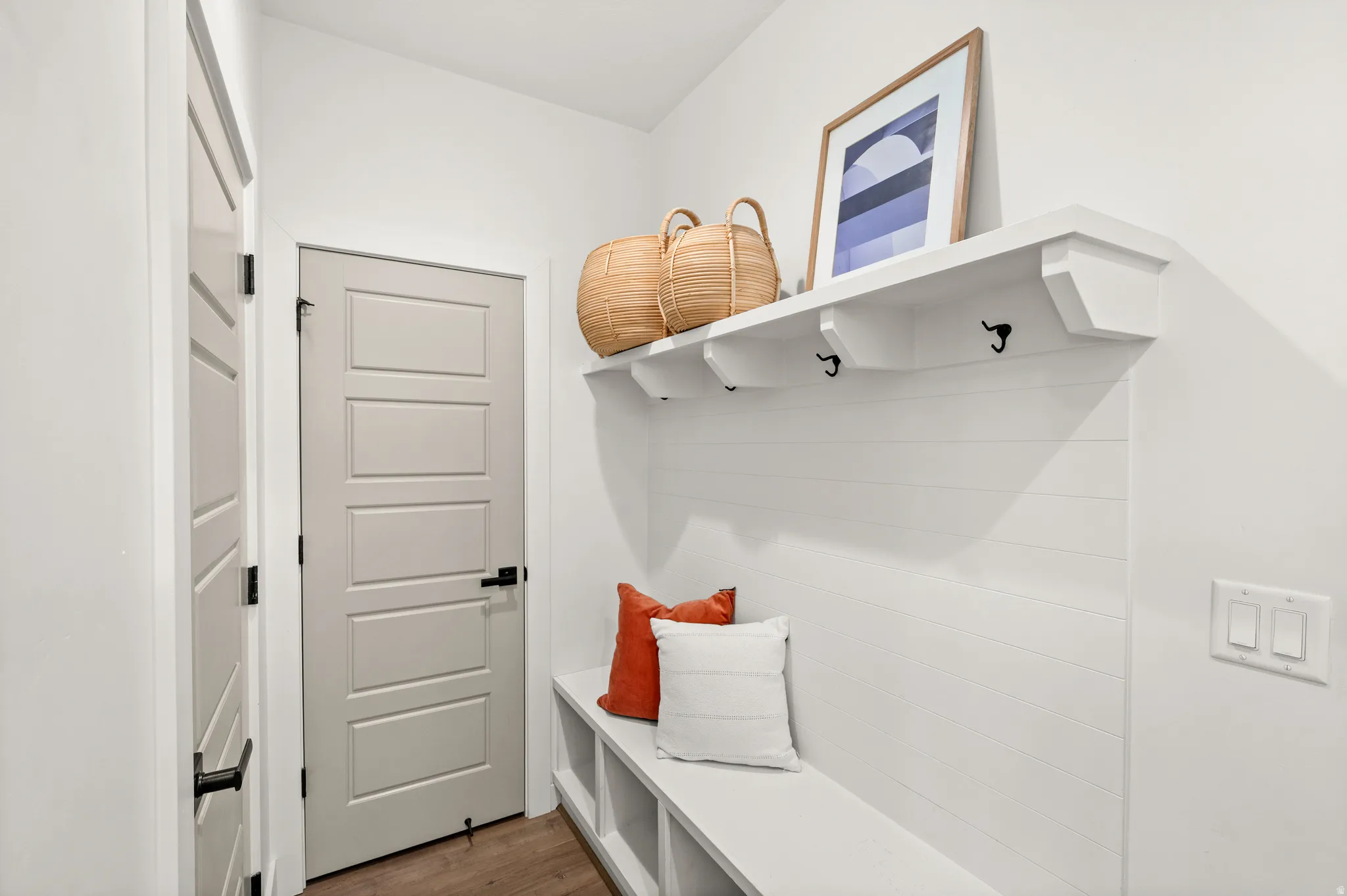 Mudroom with dark wood-style floors