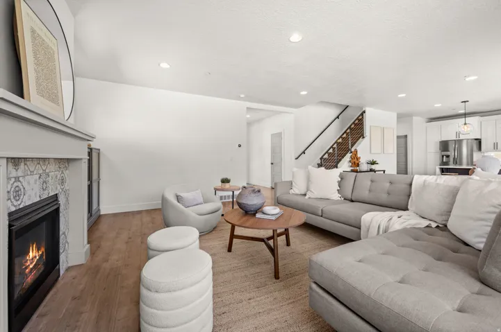 Living area with a fireplace, light wood-style floors, and recessed lighting