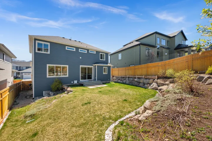 Back of property with a fenced backyard and a patio