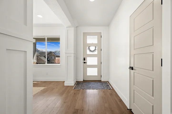 Entrance foyer featuring dark wood finished floors and baseboards