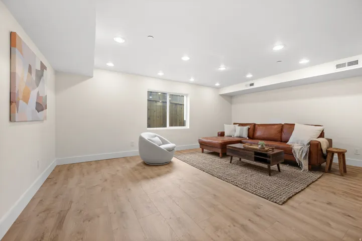 Living room featuring light wood finished floors and recessed lighting