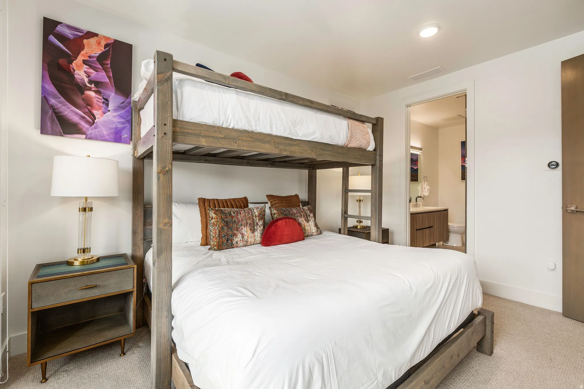 Bedroom with carpet floors and connected bathroom