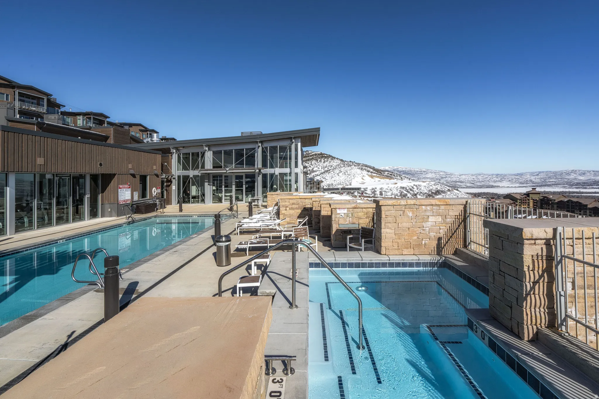Community pool featuring a patio and a mountain view