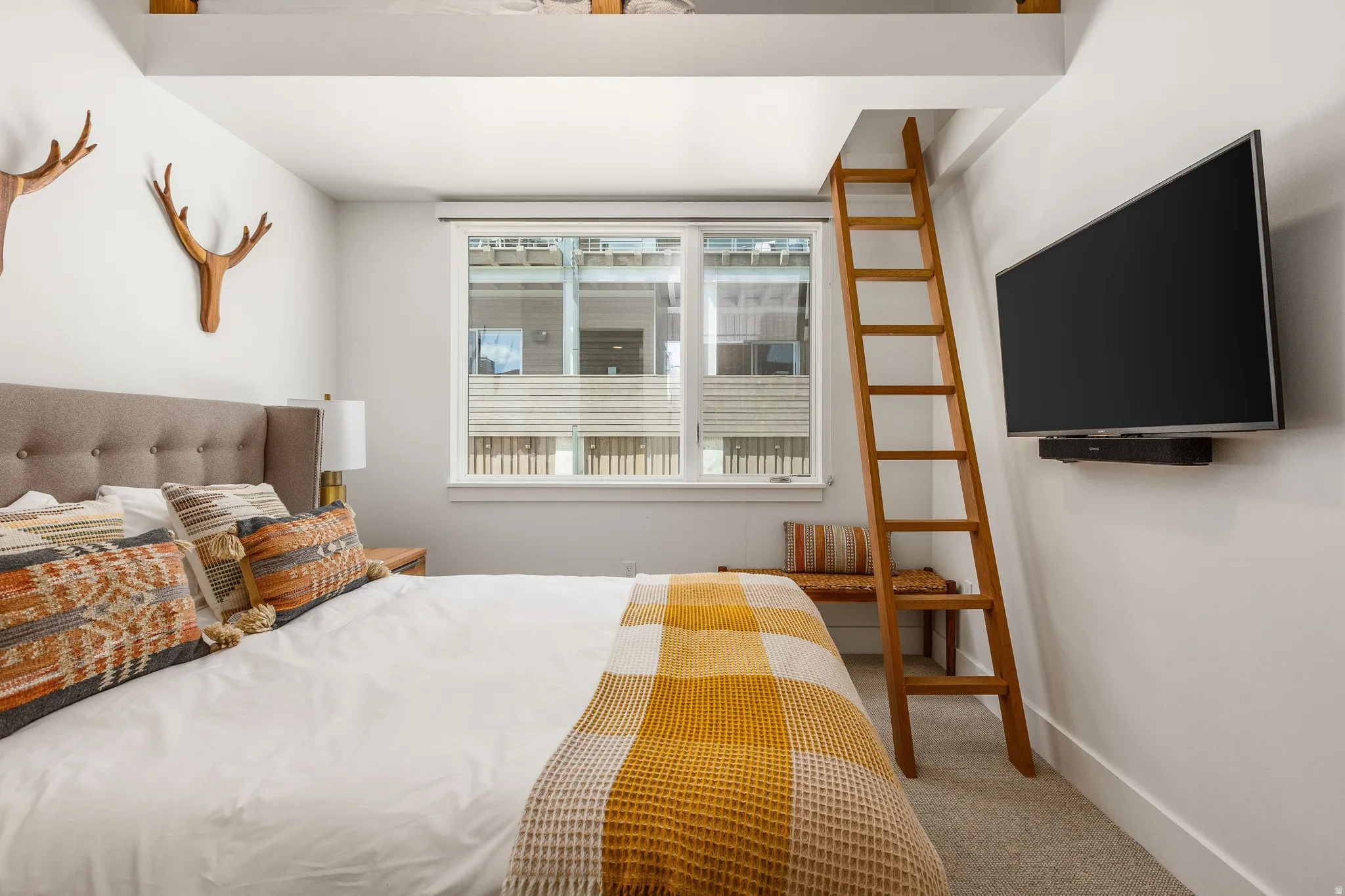 Bedroom featuring light carpet and baseboards