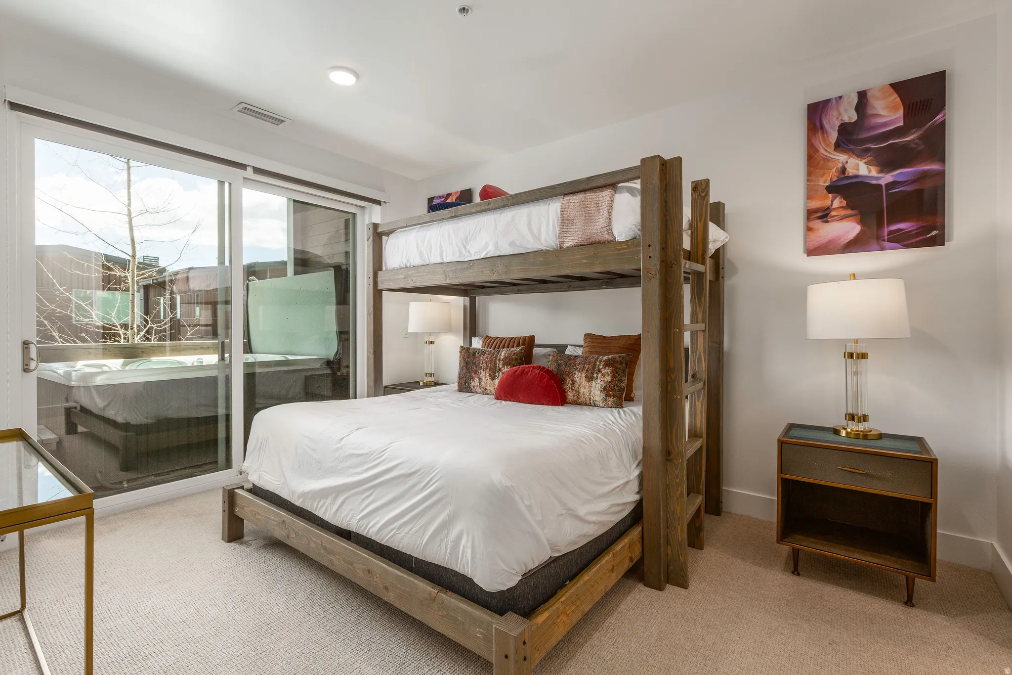 Bedroom with access to exterior and light colored carpet