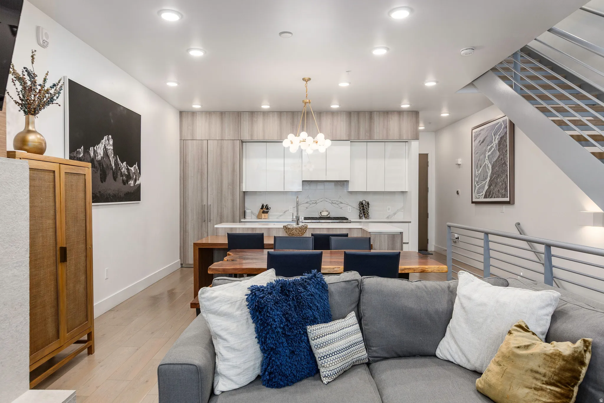 Living room with light wood-style flooring and a chandelier