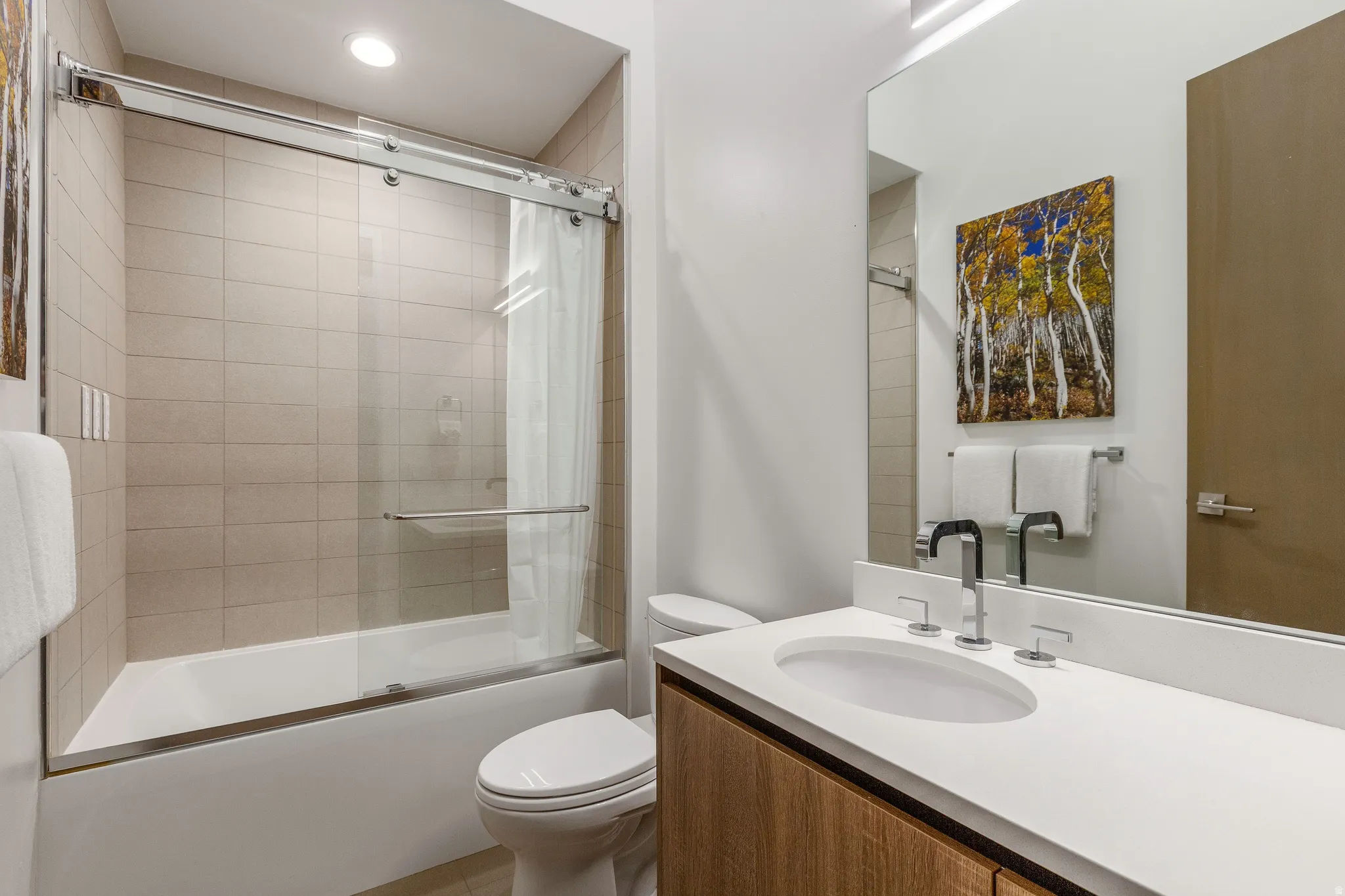 Bathroom featuring vanity and combined bath / shower with glass door