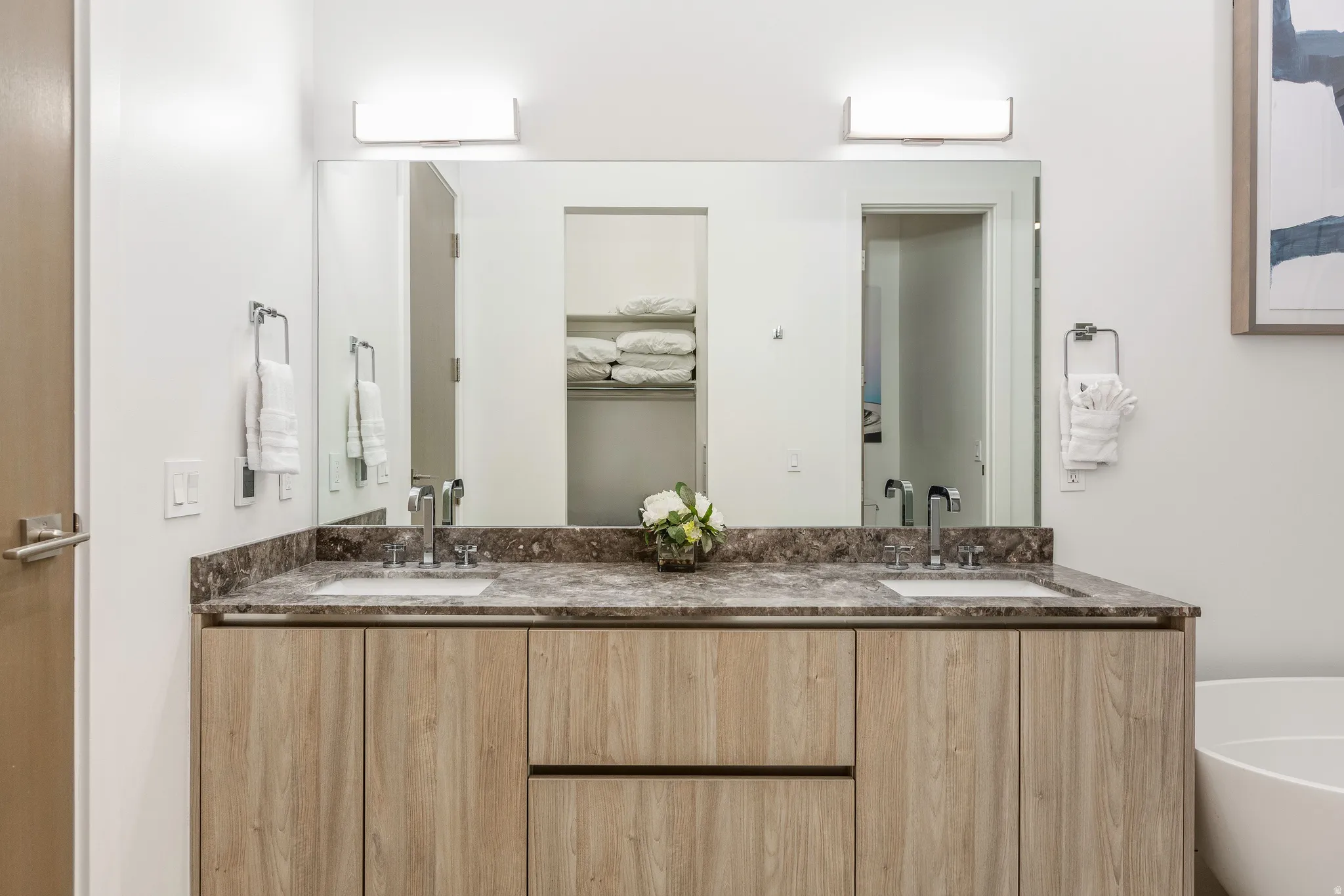 Bathroom with double vanity and a freestanding tub