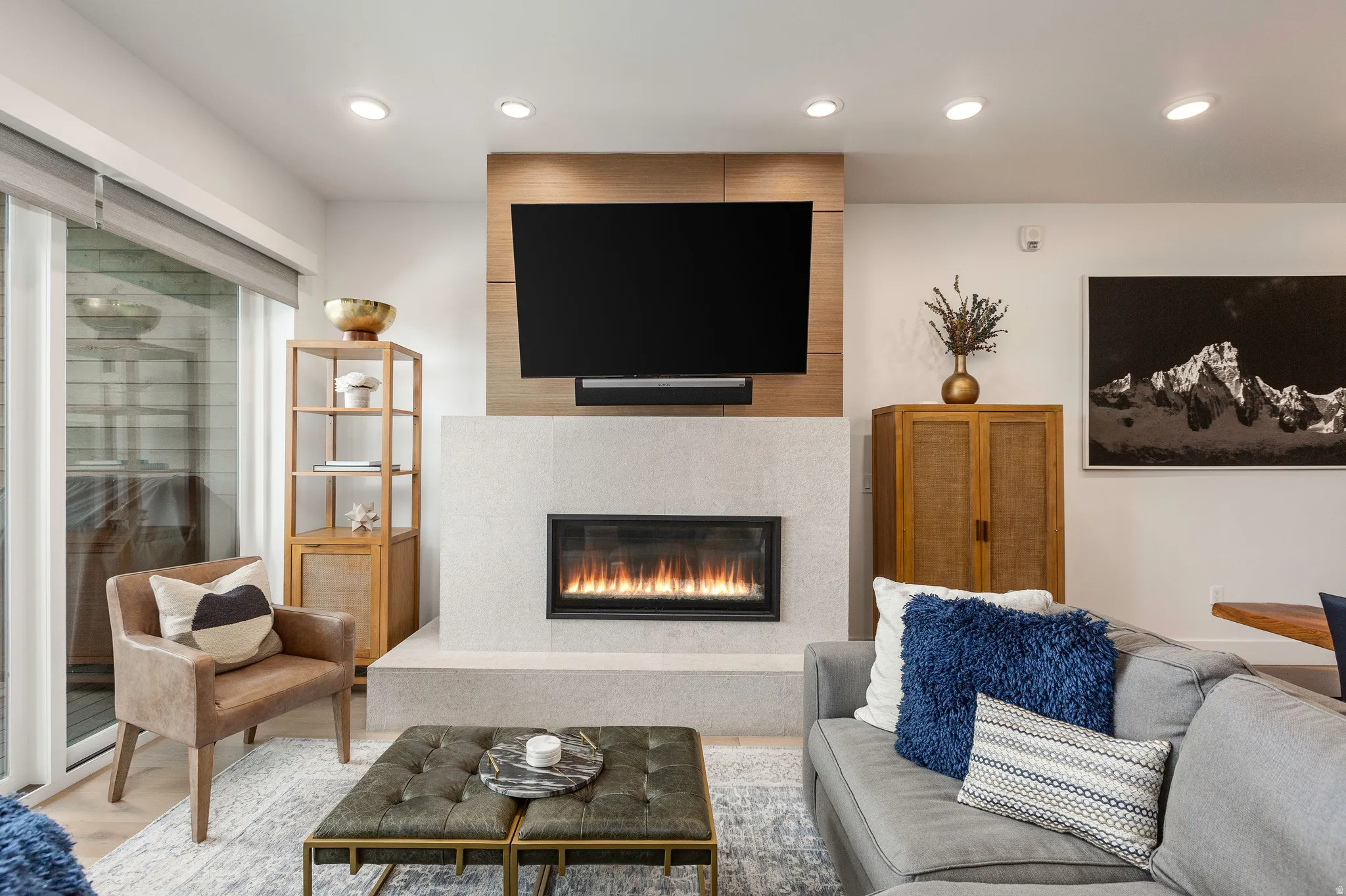 Living room featuring a large fireplace and light wood-style flooring
