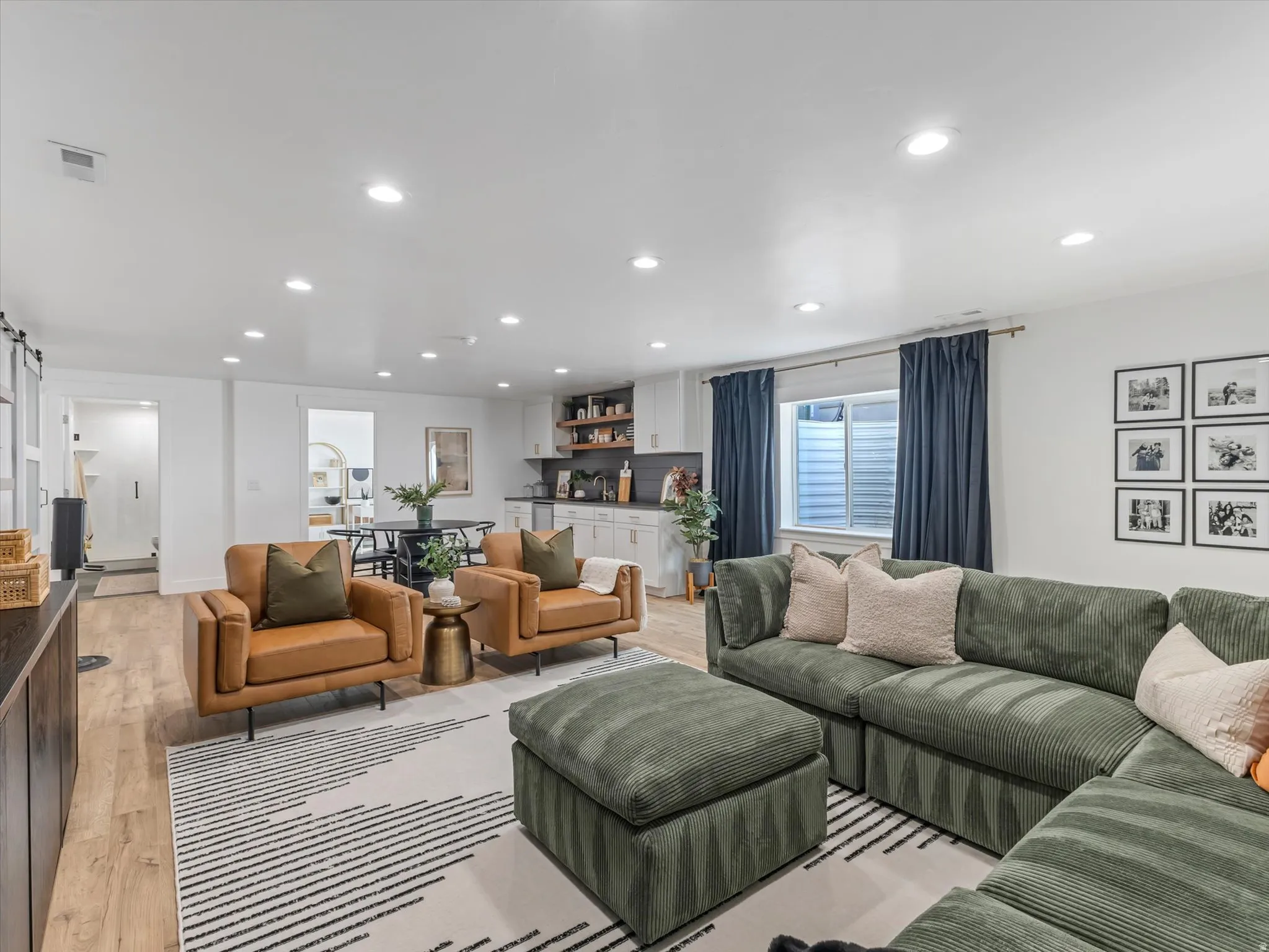 Living room featuring recessed lighting, light wood finished floors, and a barn door