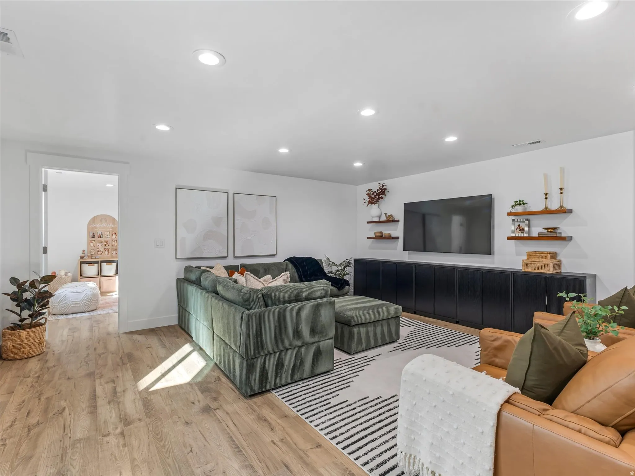 Living area featuring recessed lighting and light wood-style flooring
