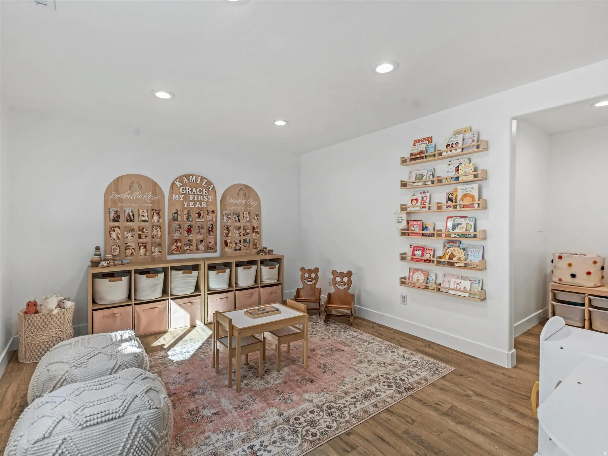Living area with dark wood-style flooring and recessed lighting