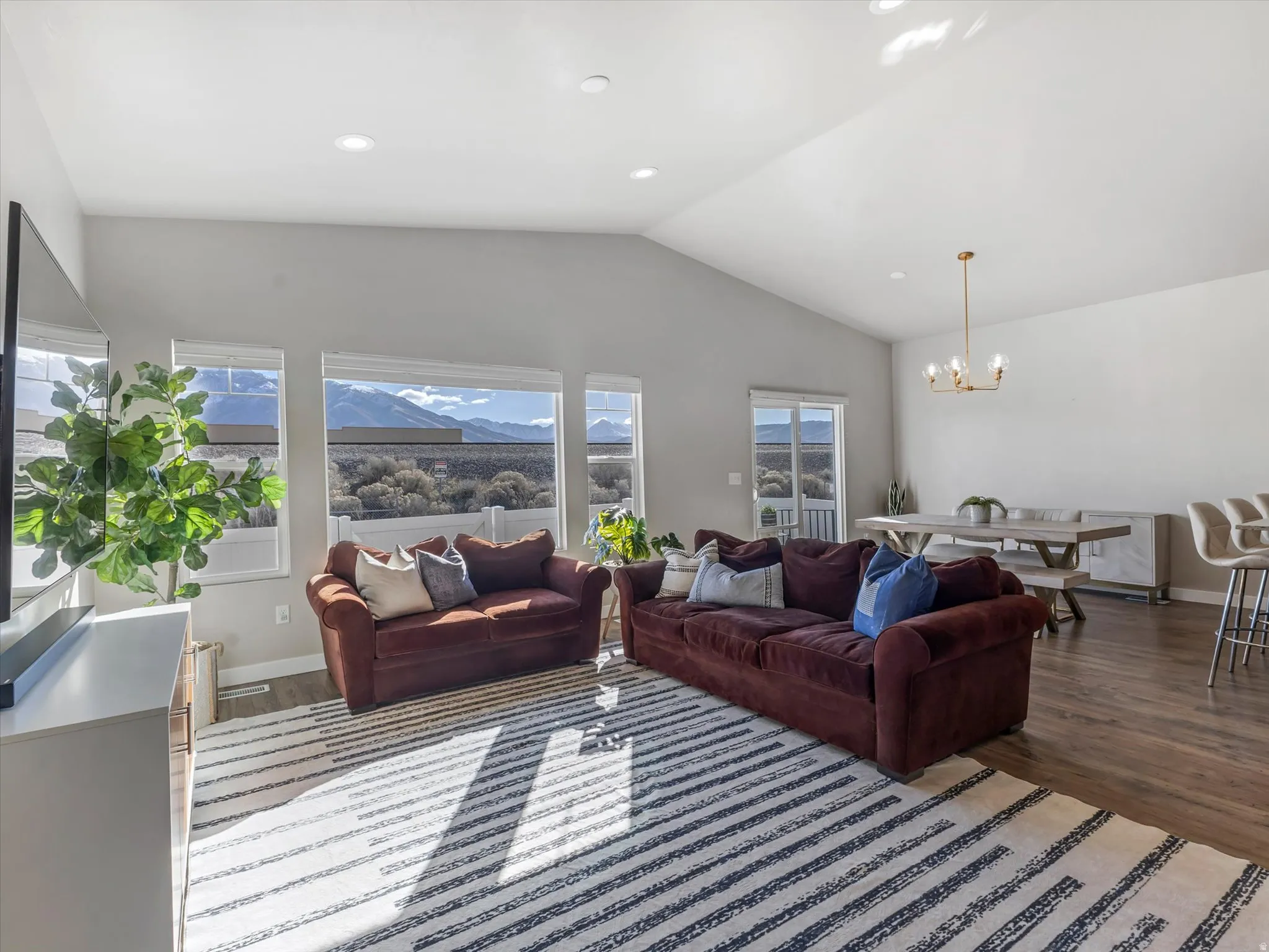 Living area featuring light wood finished floors and a chandelier