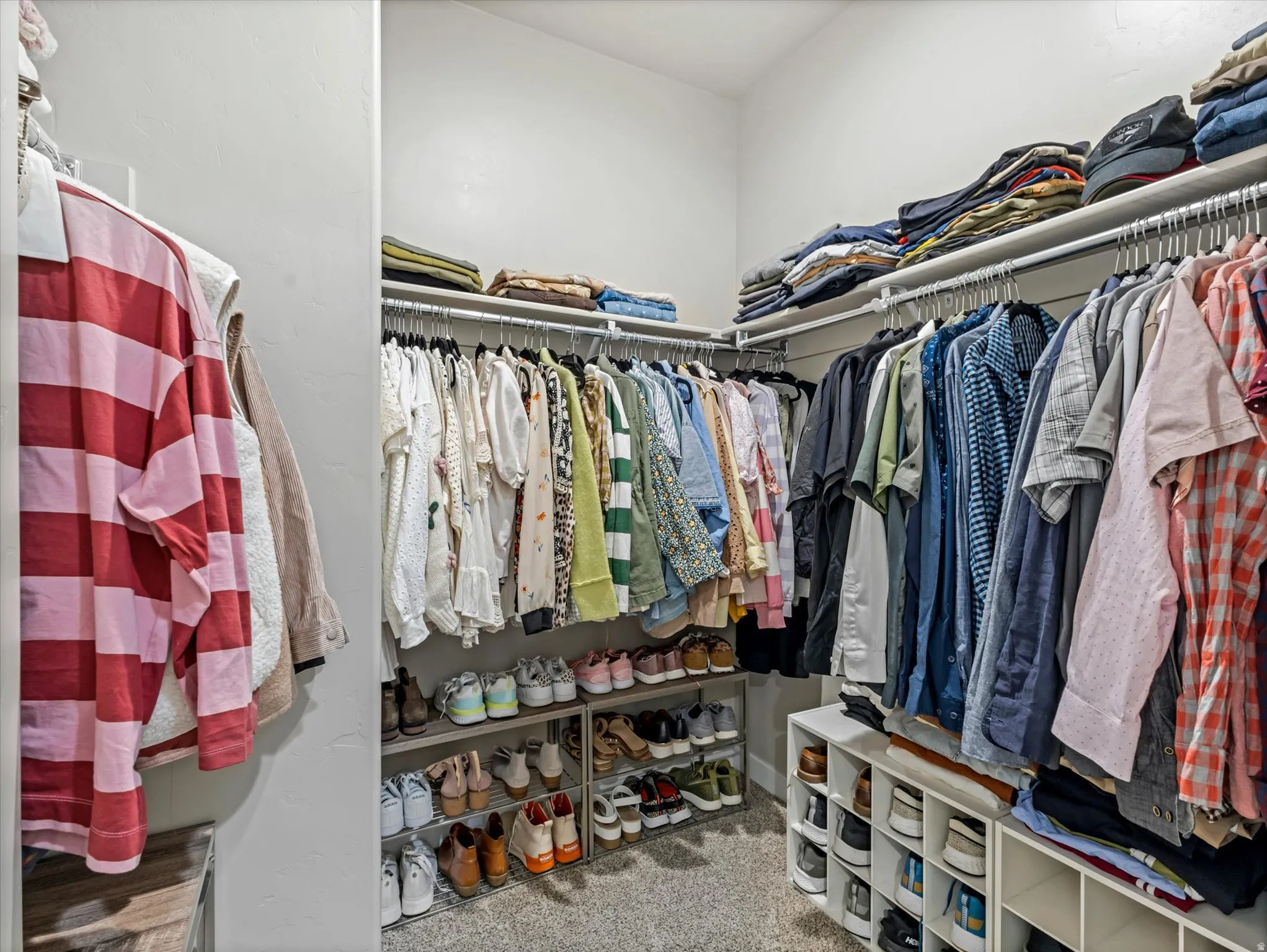 Walk in closet featuring light carpet