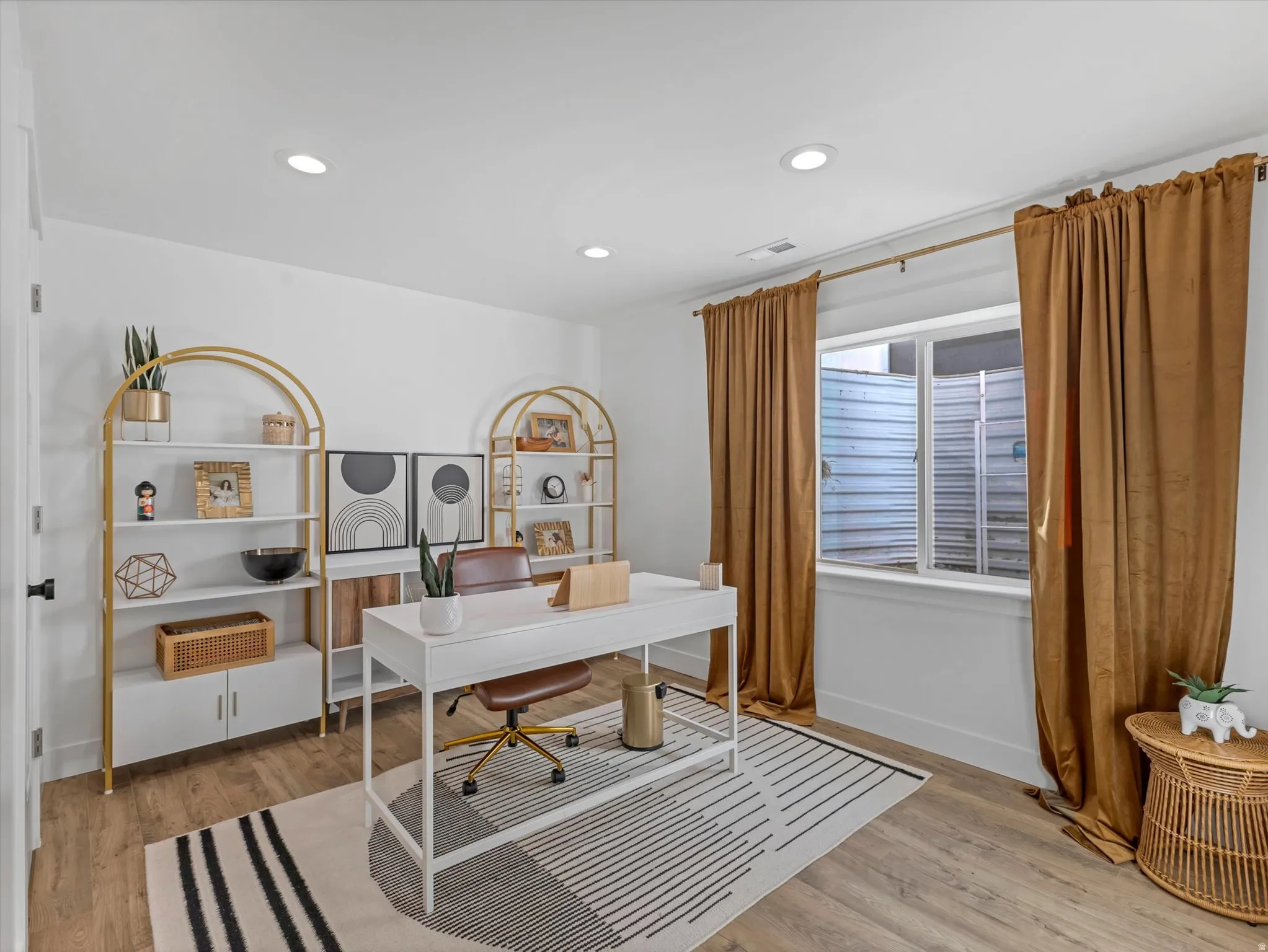 Office with recessed lighting and light wood-style flooring