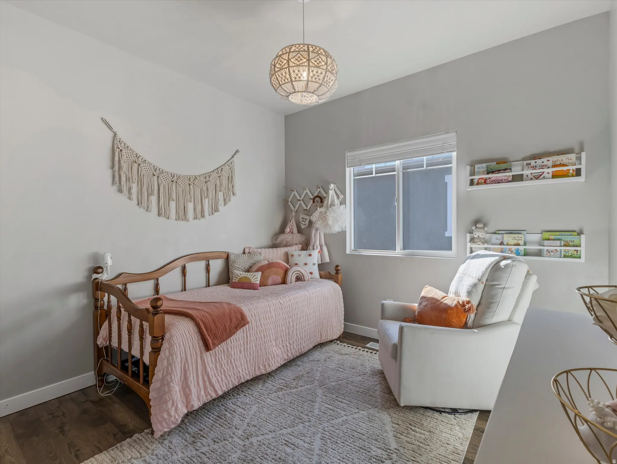 Bedroom with wood finished floors and baseboards