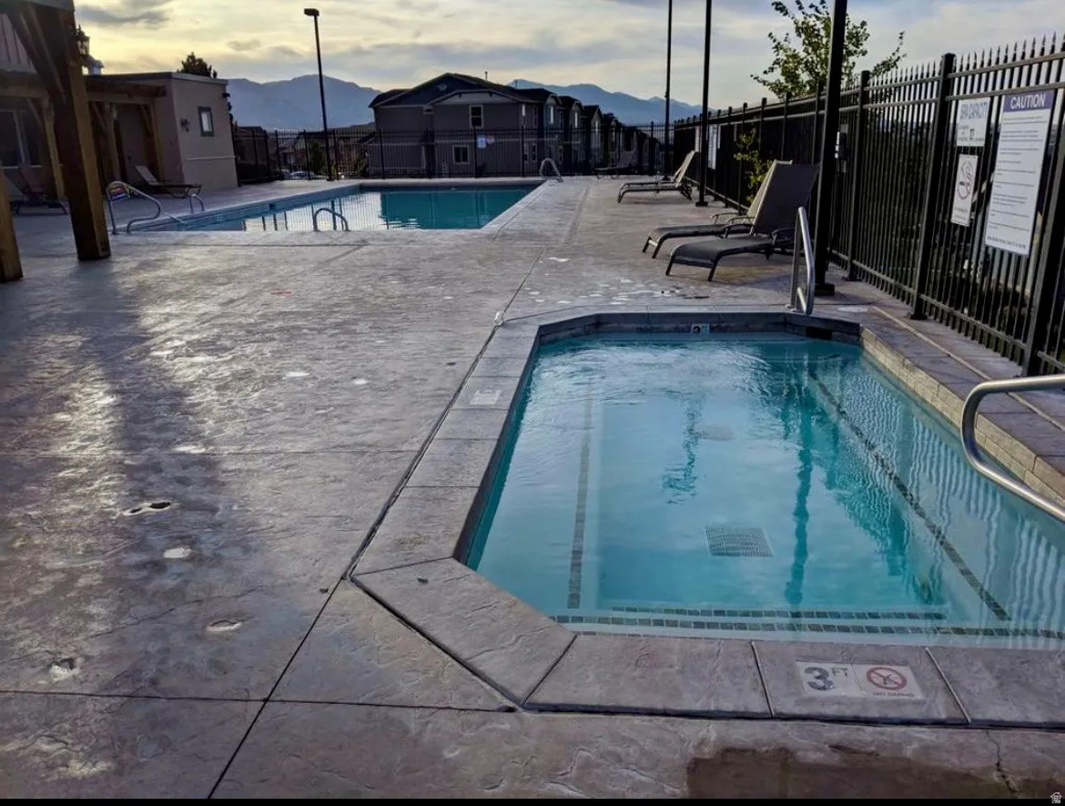 Community pool with a mountain view and a patio