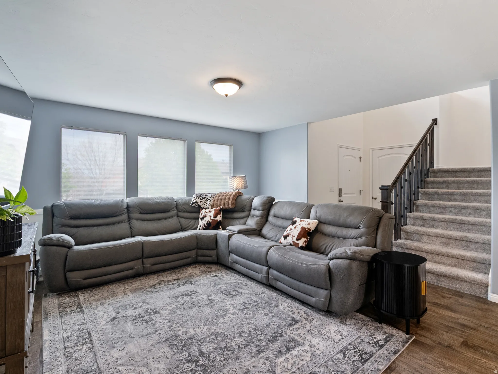 Living room featuring stairway and wood finished floors