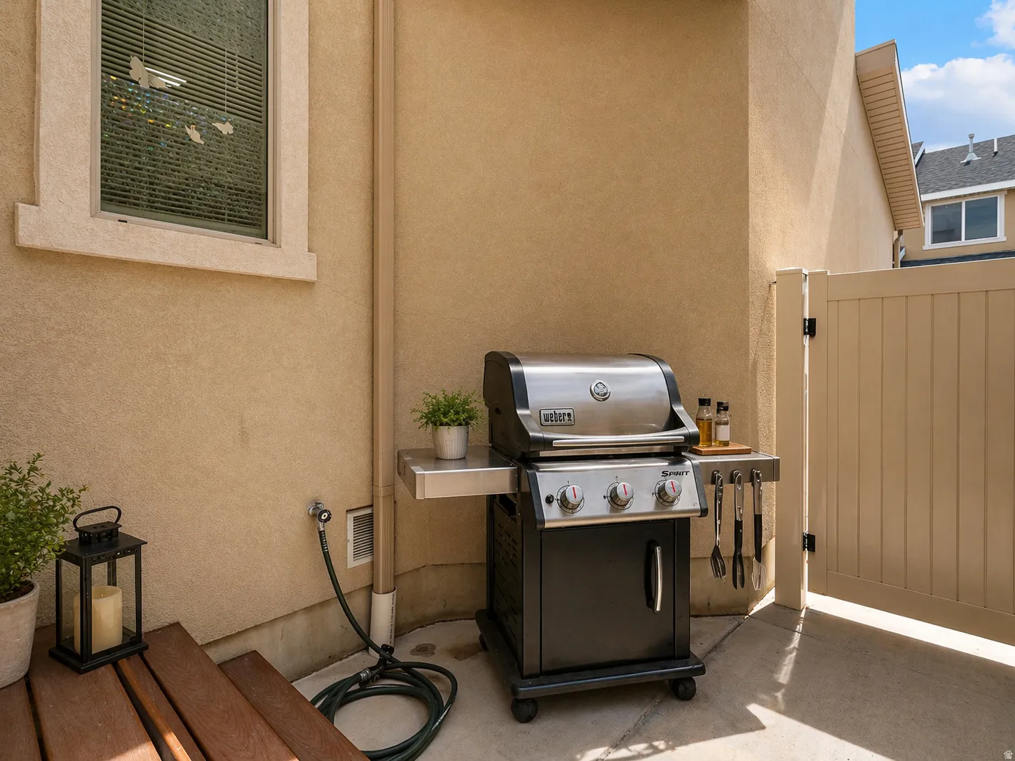 View of patio / terrace featuring a grill and a gate