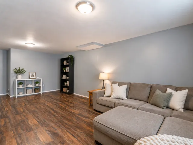 Spacious room featuring wood-finish flooring, light gray walls, and recessed lighting