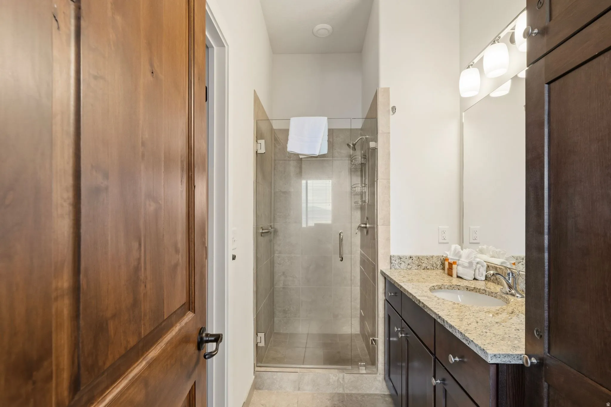 Bathroom featuring vanity and a shower stall