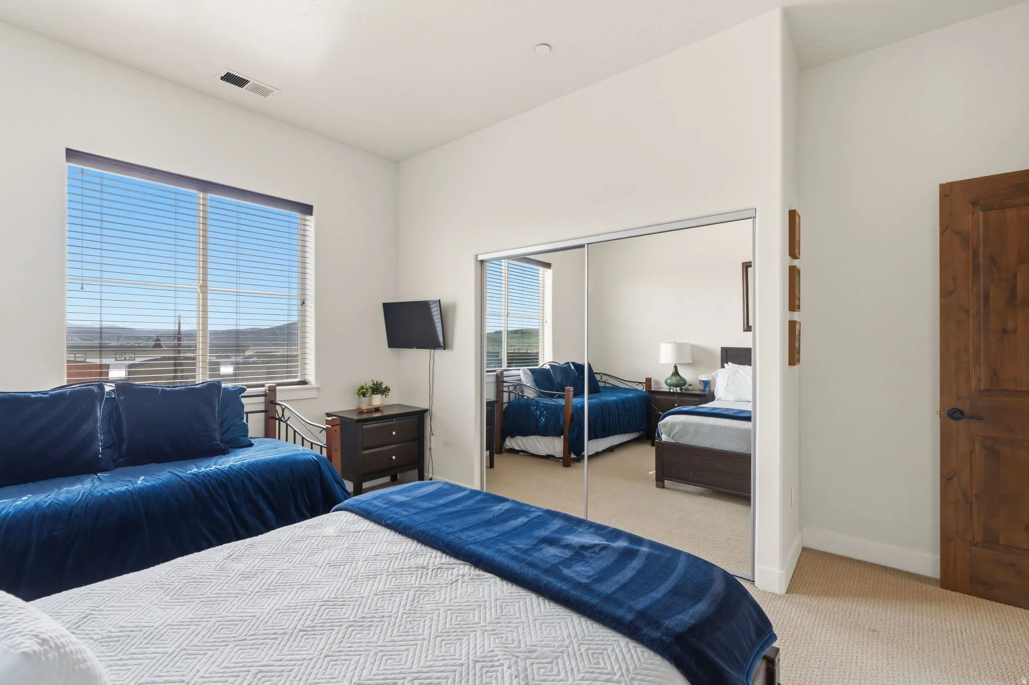Bedroom featuring light colored carpet and a closet