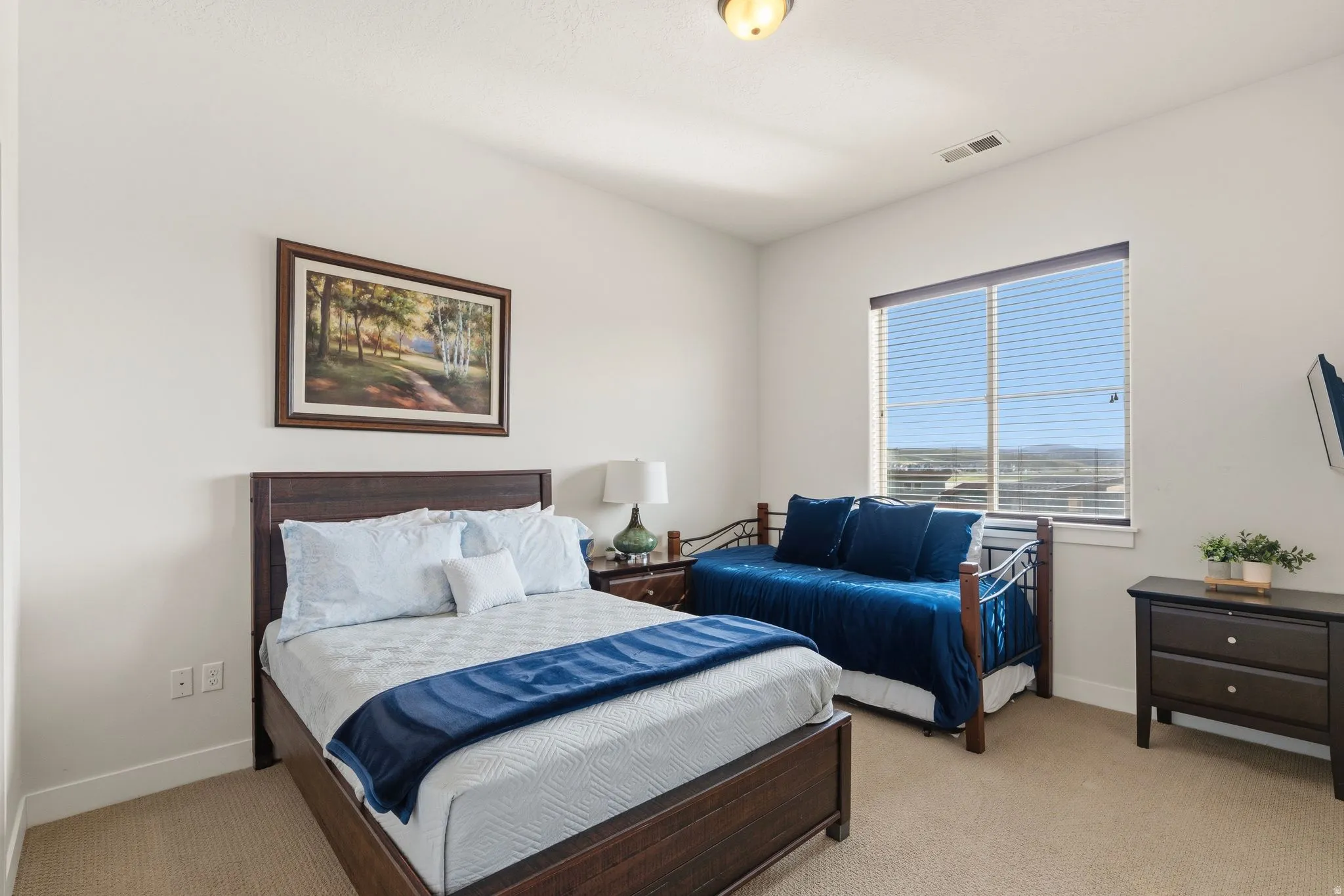 Bedroom with light carpet and baseboards