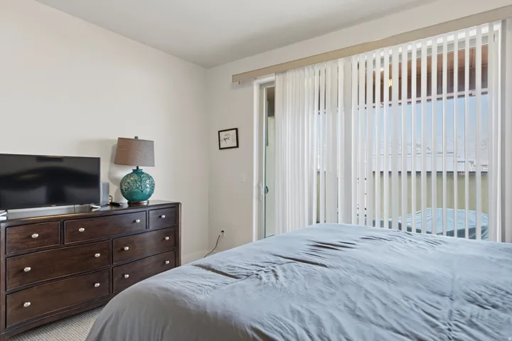 Bedroom with access to exterior and carpet